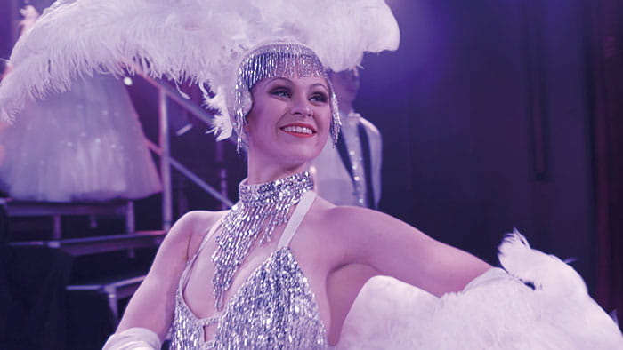 A performer on stage in the Playhouse on Spirit of Adventure